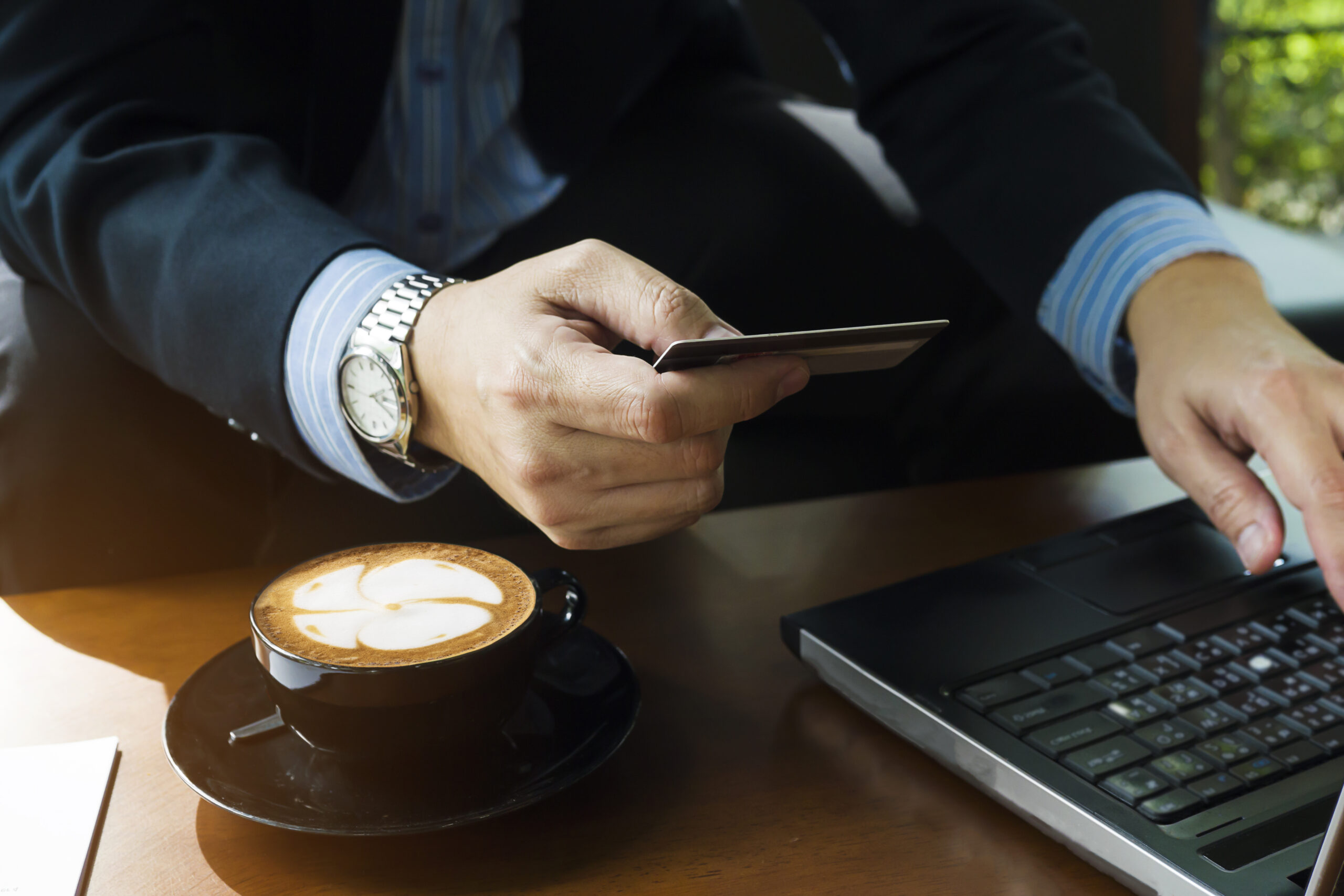 business man using credit card buy online items coffee shop scaled